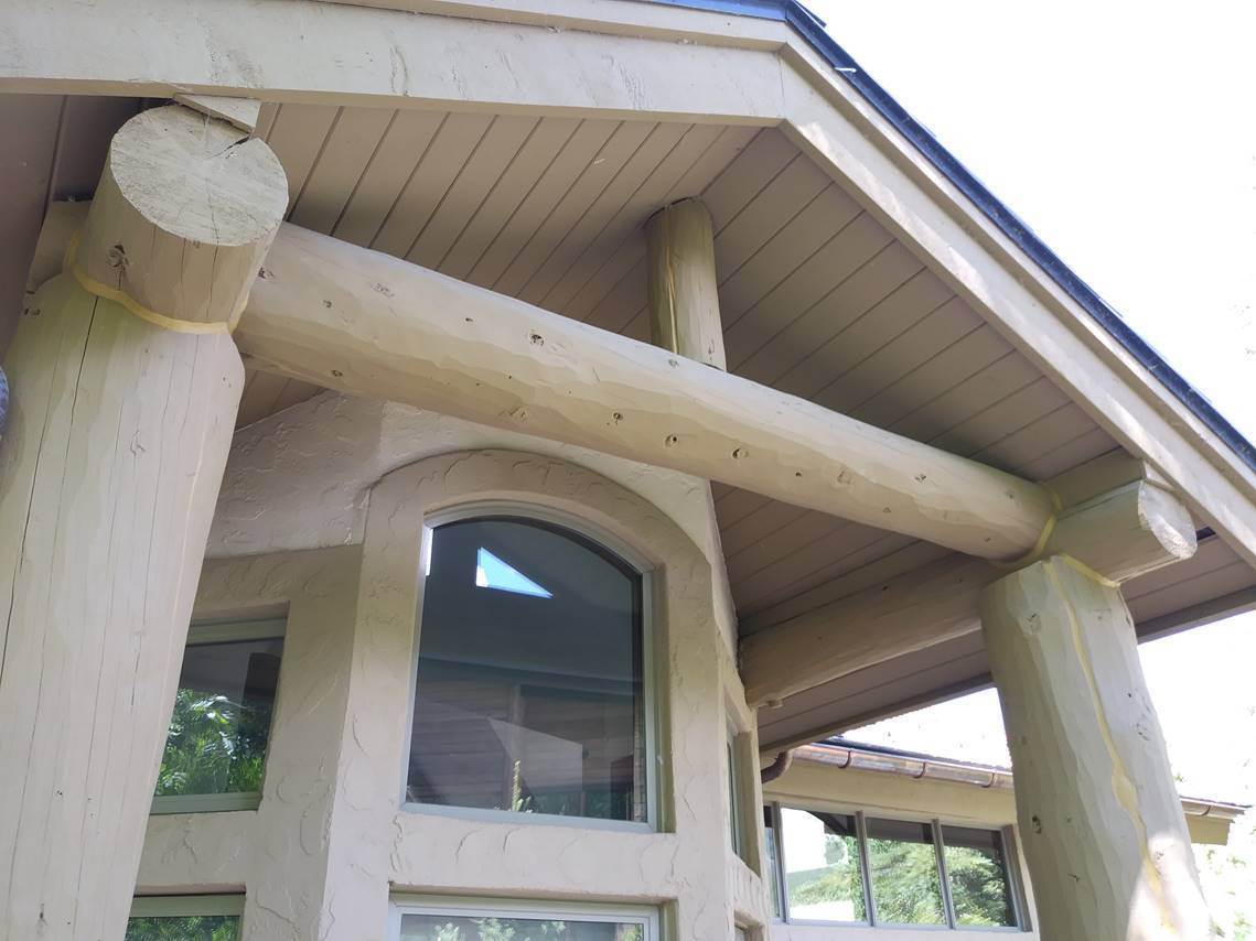 Painted timber column and beam joint with a clean hand-cut line against stucco, detail work by Sun Up Painting